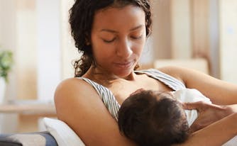 person breastfeeding baby