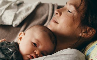 new mom and baby sleeping on couch