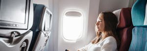 best and worst cures for jet lag - image of person sitting on airplane