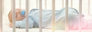 baby sleeping on crib mattress