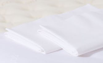 saatva pillowcases on top of bed