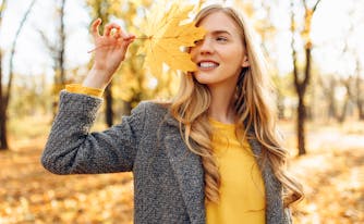 person holding leaf outside in the fall