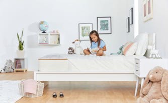 best kids mattress - image of little girl on bed