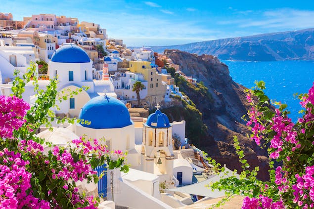 View of blue-domed buildings on Santorini, Greece on a cliffside 