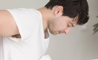 image of man with back pain in bed