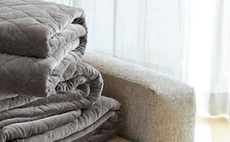 saatva organic weighted blanket folded on couch