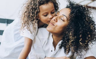 image of mom and child cuddling on bed
