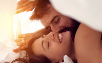 image of happy couple in bed
