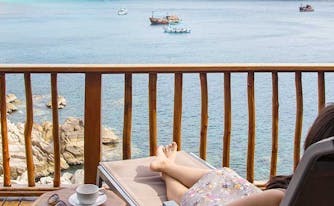 image of woman sleeping by beach while traveling