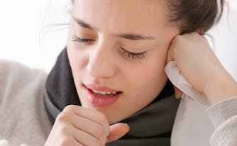 image of sick person coughing in bedroom
