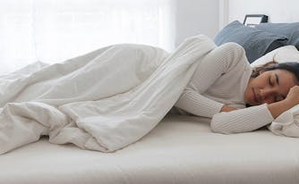 best latex mattress for side sleepers - image of woman sleeping on side
