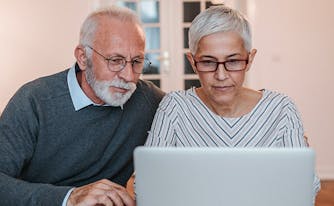 image of couple reading mattress customer reviews online