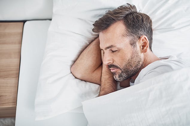 image of man sleeping in bed