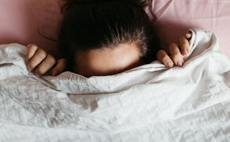 image of person with head under sheets