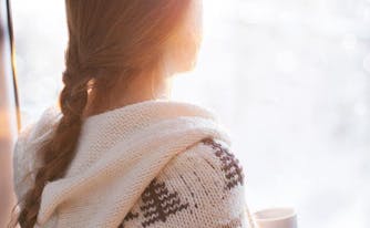 image of woman with seasonal affective disorder looking out window