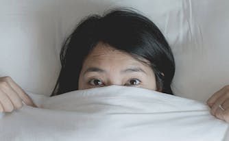 image of woman lying in bed