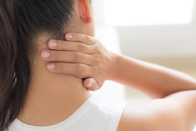 Person massaging stiff neck