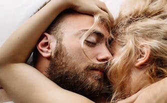 image of couple sleeping together in bed