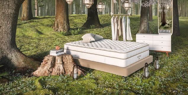 friluftsliv style bedroom with mattress outside in forest next to clothing rack