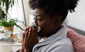 person in bed with stuffy nose at night