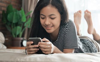 best mattress for teenagers - image of teen lying on bed