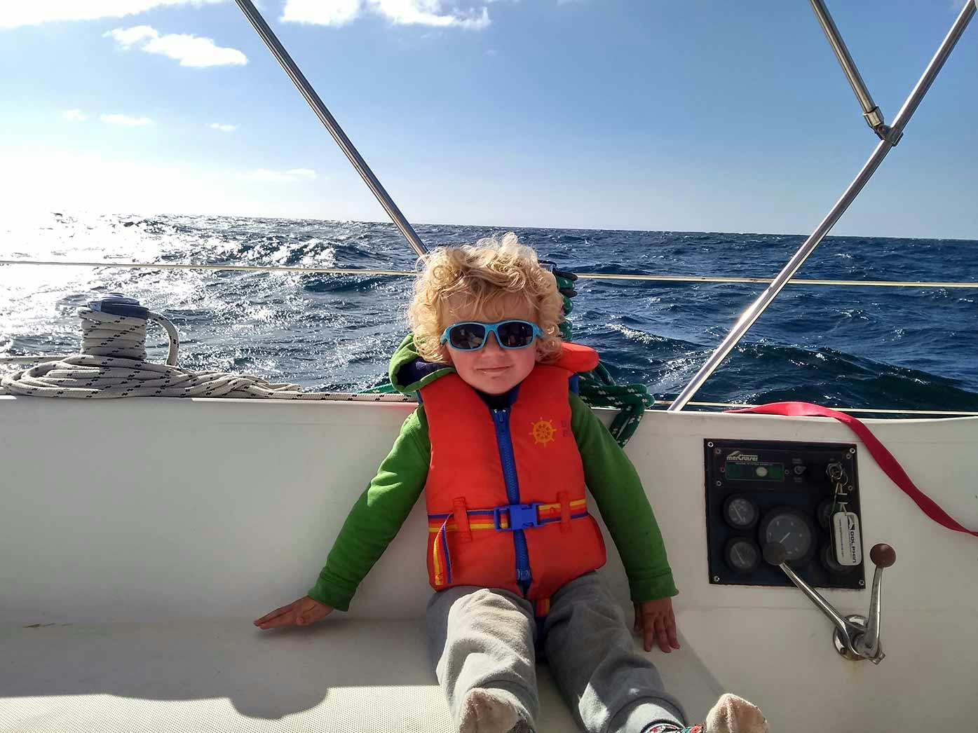 sleeping on a boat- image of little boy on boat