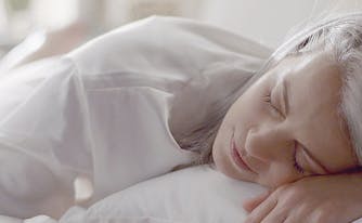 image of woman sleeping - how to break in a mattress