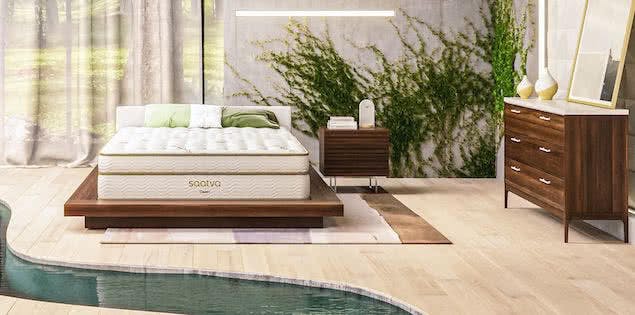 japandi style bedroom with mattress, plants, and wood furniture