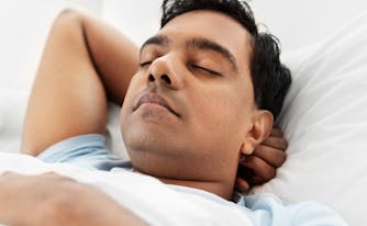 best hybrid mattress for back sleeper - image of person sleeping on back