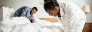 image of couple making bed -best mattress for couples