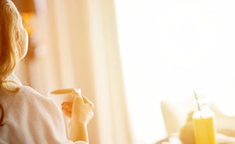 image of woman sitting in hotel room