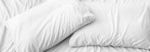two old pillows on top of bed