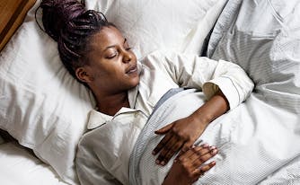 best mattress for back sleepers -image of woman sleeping on back