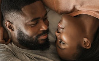 image of couple sleeping in bed with one person snoring
