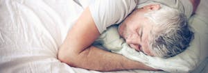 best latex mattress for stomach sleepers - image of man lying on stomach