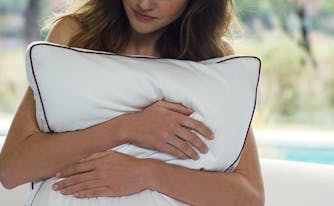 how to pick the best pillow - image of woman hugging pillow