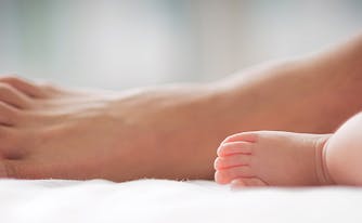 image of woman and baby's feet - best mattress for your age