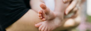 sleep tips for new parents - image of mom holding baby