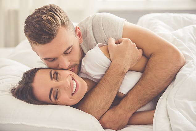 image of couple in bed snuggling
