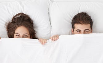 sleep habits of couples survey results - image of couple in bed