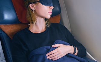 image of woman sleeping on airplane