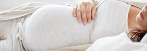 image of pregnant woman sleeping - best mattress for pregnancy
