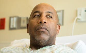 image of person with cancer in hospital bed