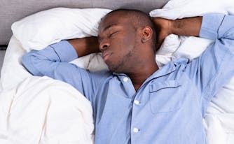 image of person sleeping on back in bed