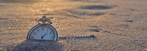 circadian rhythm - image of clock outside in sand