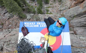 image of author phoebe smith on the side of a cliff
