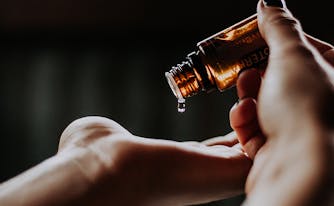 best essential oils to help sleep - image of essential oil in hand