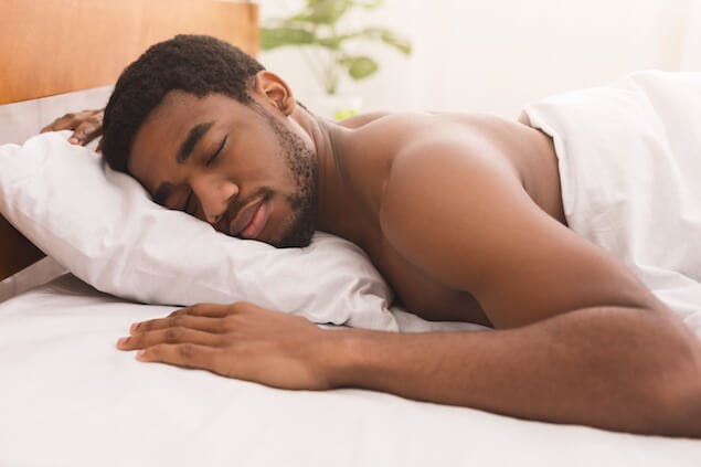 person sleeping on stomach, which can cause a stiff neck