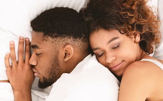 best sex pillow - image of couple cuddling in bed