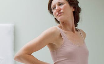 image of woman in pain from sleeping on old mattress